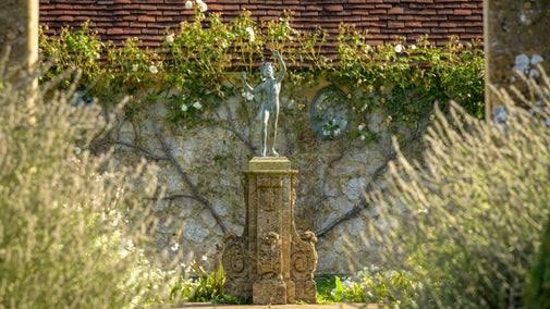 A statue of Bacchus in the White Garden at Barrington Court